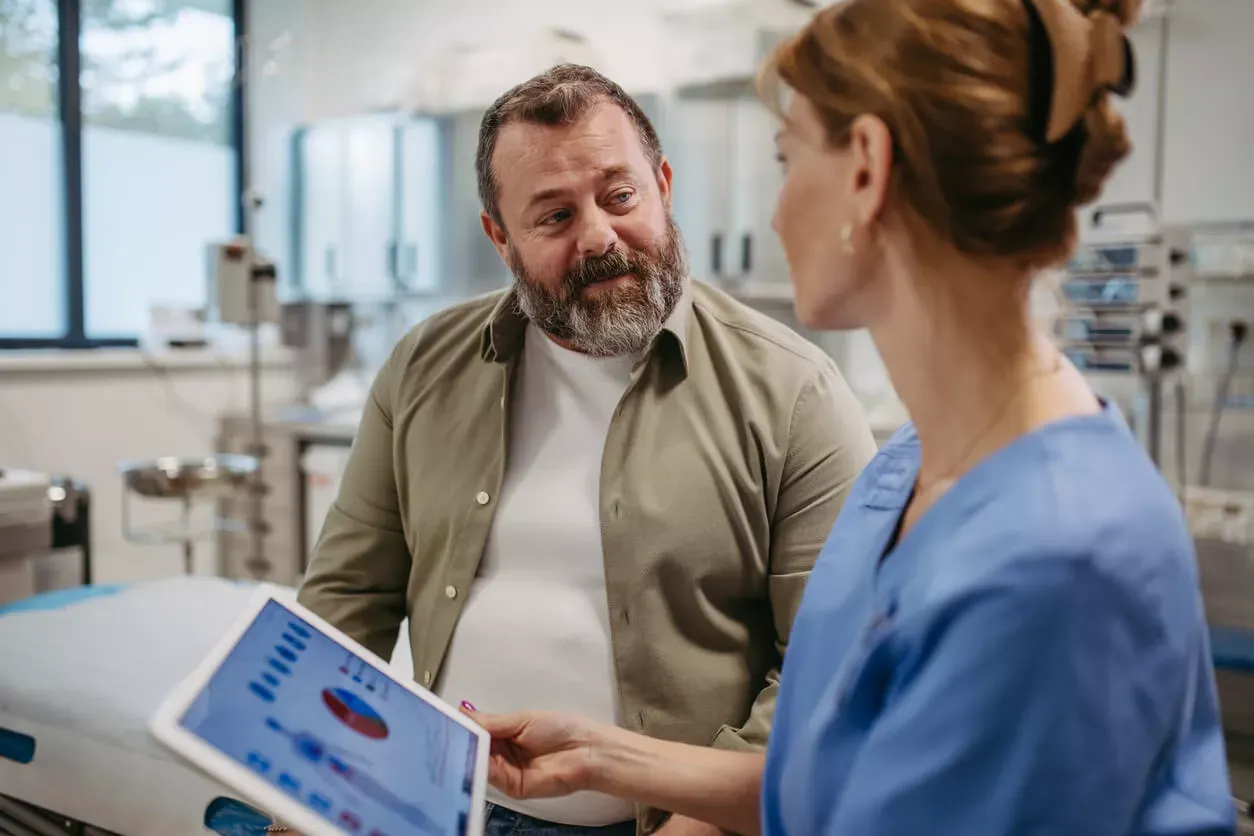 Middle-aged man conversing with a clinician
